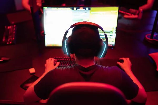 A row of dark gaming chairs and monitors at BLOOP's Wave rows stations