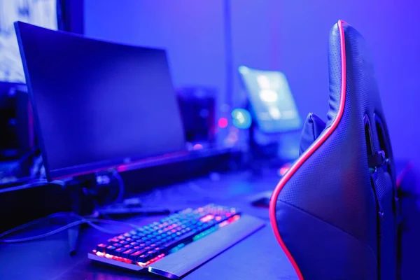 A quiet single gaming station in a soft-lit back corner at BLOOP's Deep corner seats